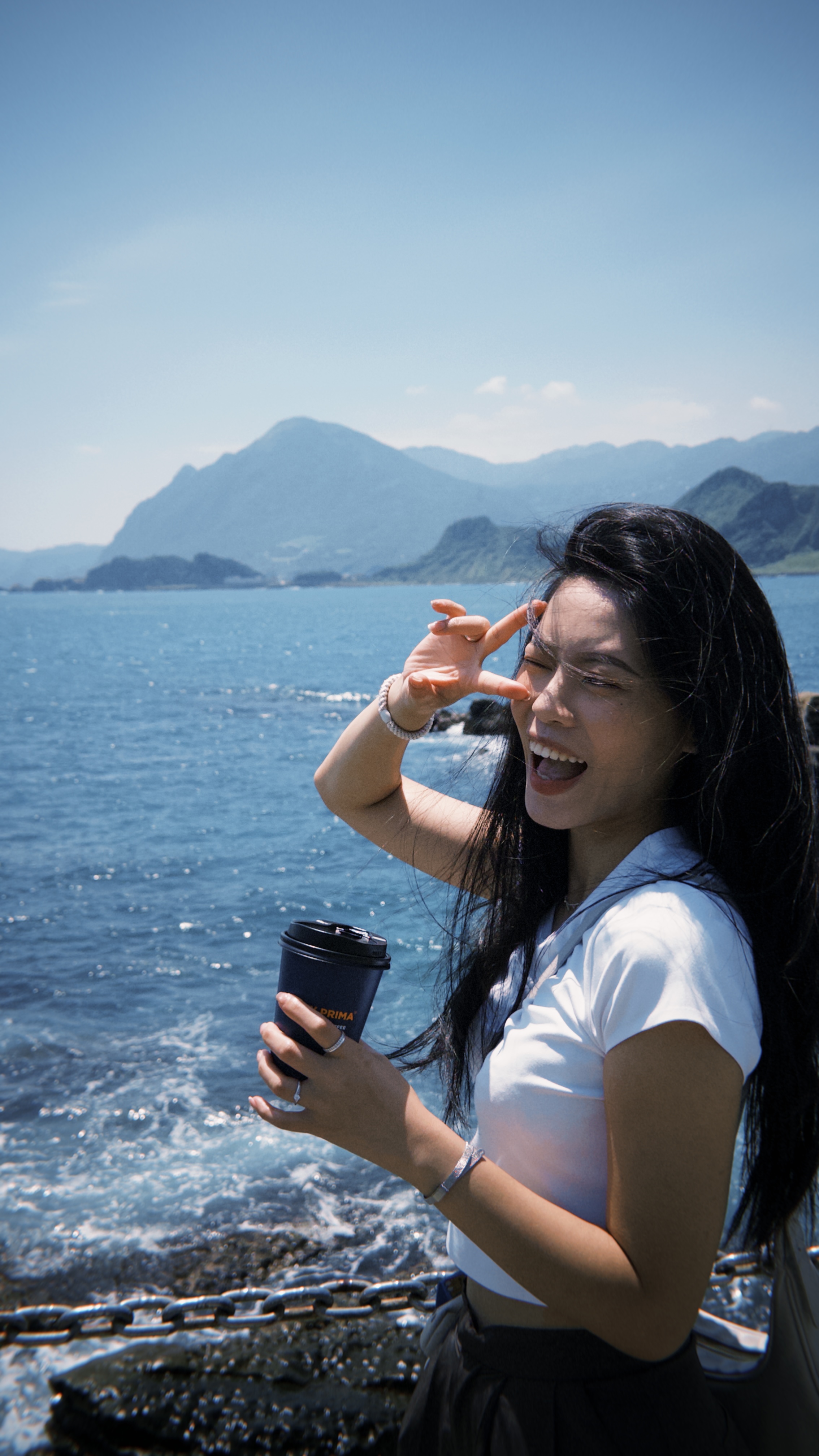 Portrait by the sea with mountains in the background